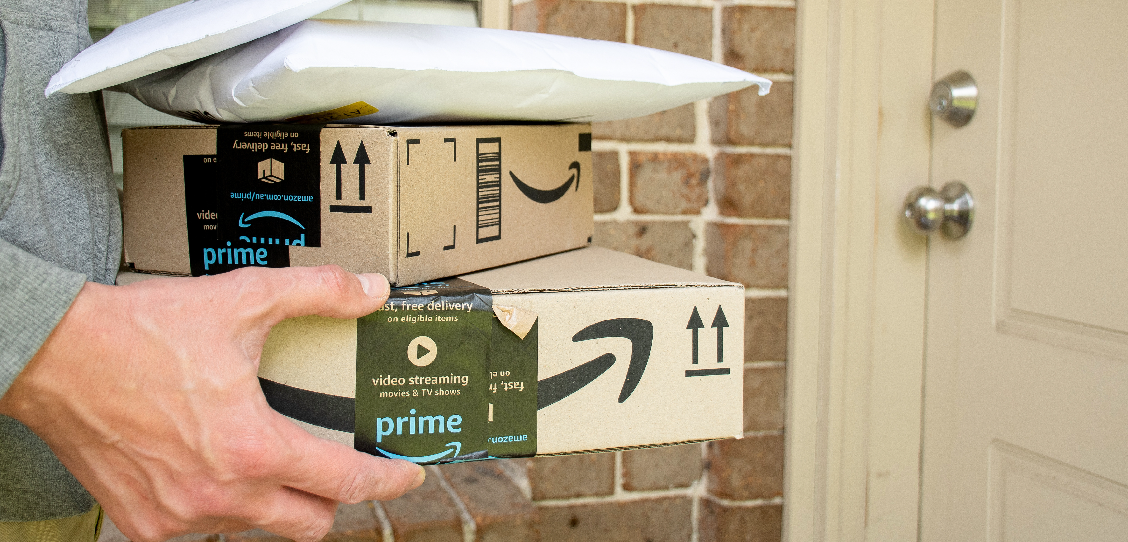Man carrying Amazon Prime Day boxes