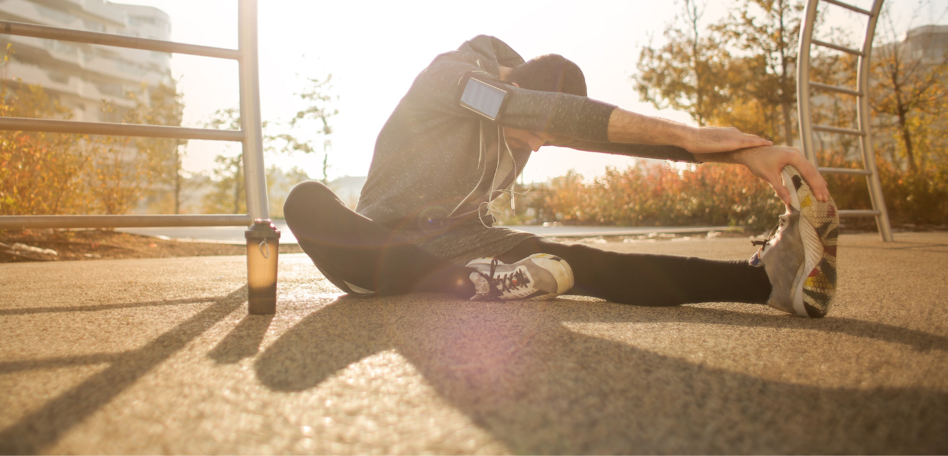 Woman stretching in the settling sun, optimizing her body for seasonal change and getting more sunlight