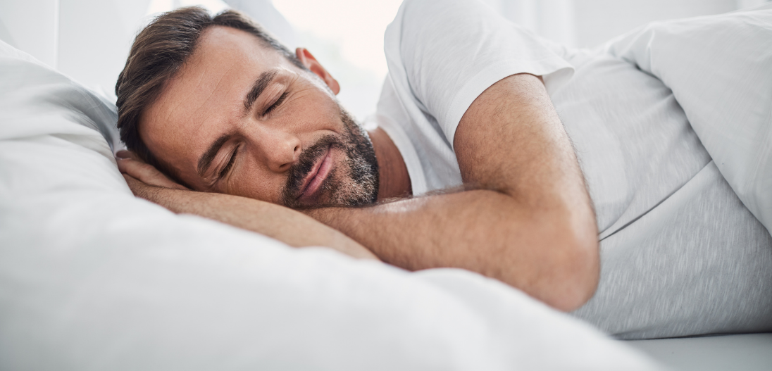 Man sleeping in his bed 