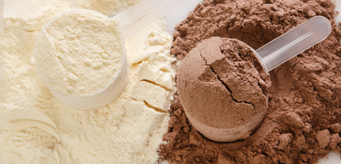 A scoop of vanilla protein powder and a scoop of chocolate protein powder