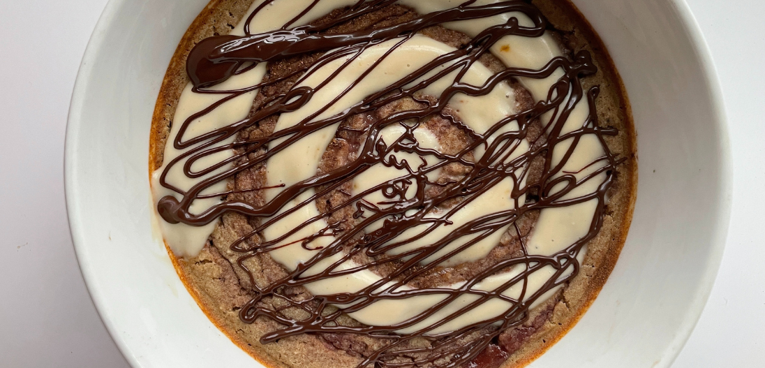 Cinnamon roll protein baked oats with cinnamon swirl and chocolate drizzle