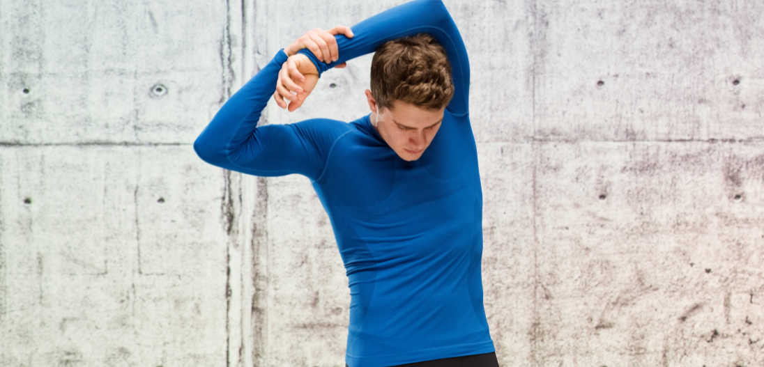 Man stretching after a workout to optimize post workout recovery and lessen muscle soreness