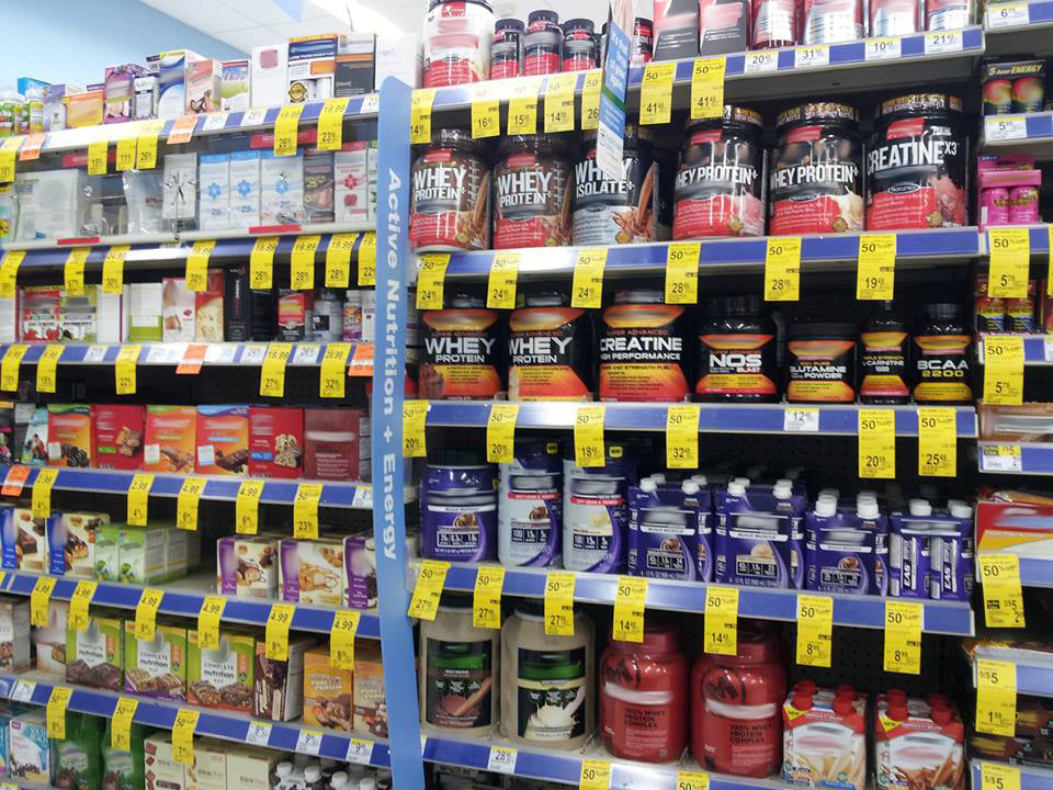 A lot of supplement jars and bottles in the store rack.