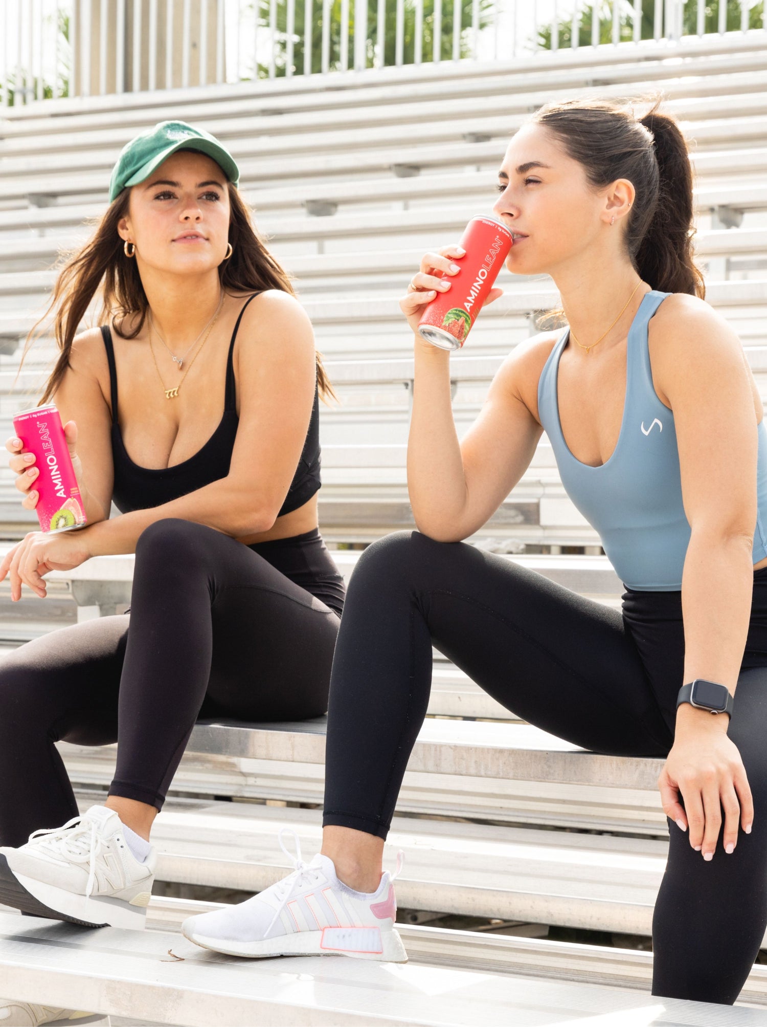 two women drinking amino lean energy drink in kiwi guava and strawberry watermelon