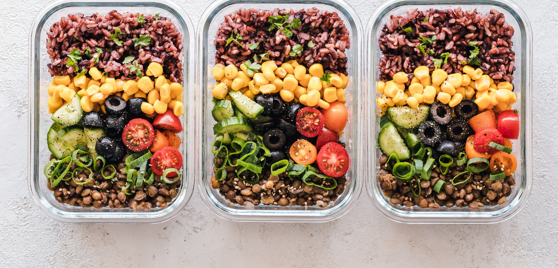 Meal prep containers with whole foods meals for calorie deficit